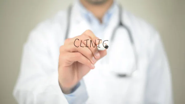 Clinic, Doctor writing on transparent screen — Stock Photo, Image