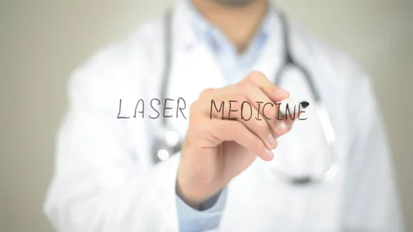 Laser Medicine , Doctor writing on transparent screen