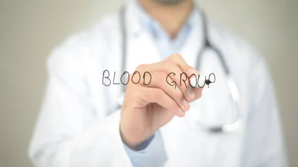 Blood Group , Doctor writing on transparent screen Stock Picture