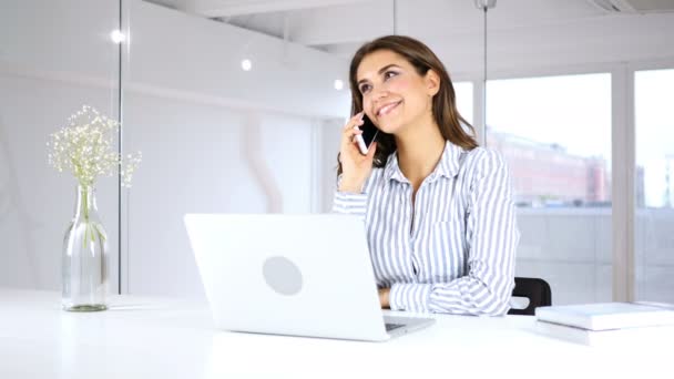 Vrouw praten over de telefoon op het werk met klant — Stockvideo