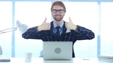 Kızıl saçlı işadamı yapıyor başparmak yukarı hareketi her iki eliyle