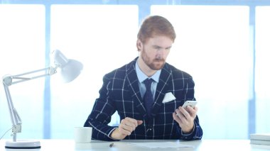 Okuma için Smartphone kullanarak kırmızı tüyler adamla nad mesajlar, e-postaları