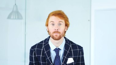 Kamerada merakla bakan sakallı adam portresi