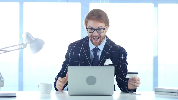 Redhead Businessman Excited for Online Shopping, Payment by Credit Card