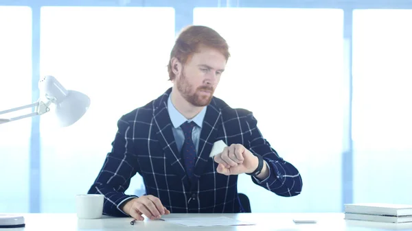 Redhead Man Waiting for Meeting, Watching Time on smartwatch