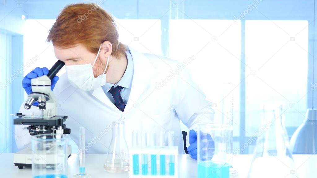 Scientist using Microscope in Laboratory for Research