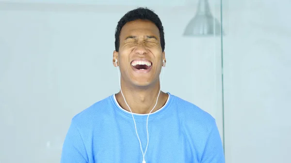 Knappe Afro-Amerikaanse Man met hoofdtelefoon lachen in oren — Stockfoto