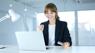 Genç erkek başarılı çevrimiçi işlem, kredi kartı ile ödeme için heyecanlı