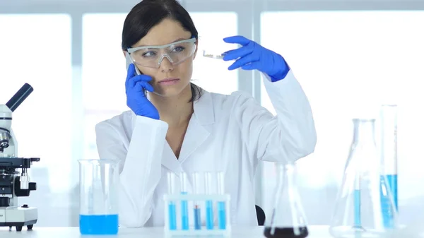 Scientist Sharing Information, Talking on Phone in Laboratory