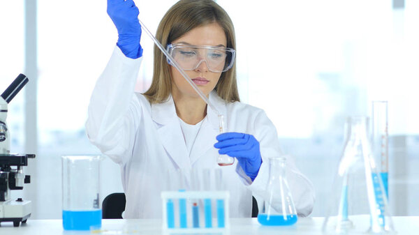 Female Scientist Busy Doing Research and Reaction in Laboratory