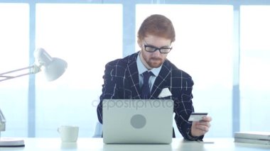 Kızıl saçlı işadamı Online alışveriş, kredi kartı ile ödeme meşgul