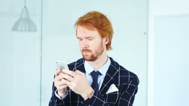 Ο άνθρωπος γένια χρησιμοποιώντας Smartphone στο χώρο εργασίας — Αρχείο Βίντεο