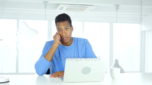Afro-American Man Talking on Phone, Attending Call at Work — Stock Video