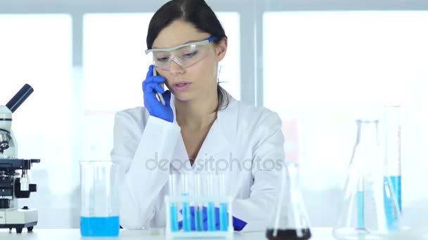 Scientist Sharing Information, Talking on Phone in Laboratory — Stock Video