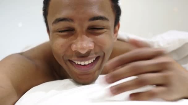 Online Video Chat by African Man Lying in Bed, Close Up — Stock Video