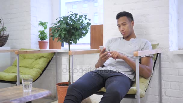 African Designer Working on Smartphone, Typing, Browsing — Stock Video