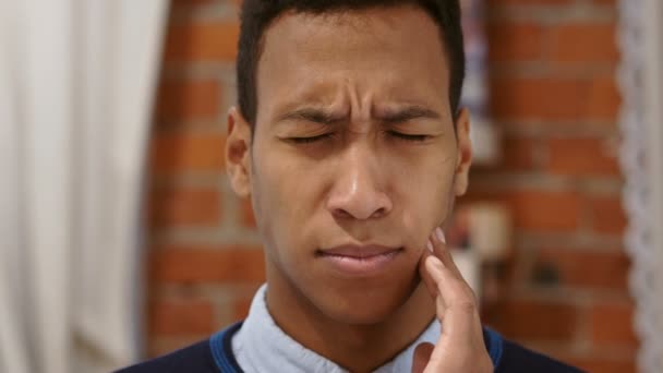 Frustrato uomo africano sdraiato a letto che soffre dolore ai denti, mal di denti — Video Stock