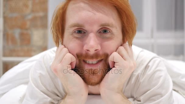 Close Up of Smiling Redhead Beard Man Face Lying in Bed — Stock Video