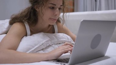 Düşünme düşünceli erkek yatakta dizüstü bilgisayar, iş çalışma