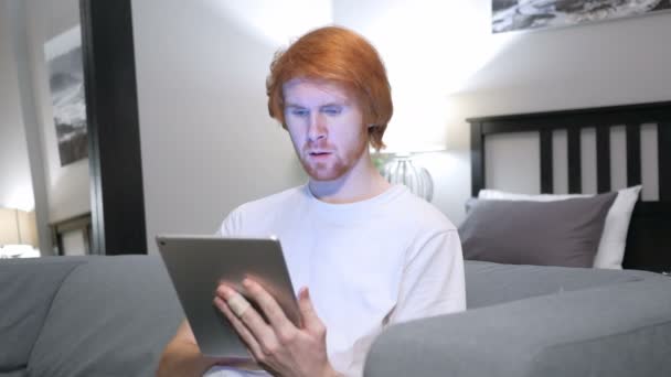 Shock, Wondering Redhead Man Using Tablet in Bedroom — Stock Video