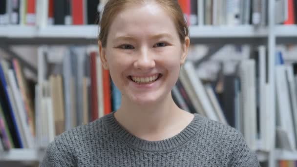Porträtt av leende ung kvinna sitter och arbetar på bärbar dator — Stockvideo