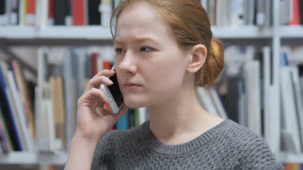 Mujer hablando por teléfono móvil, discutiendo un tema — Vídeo de stock