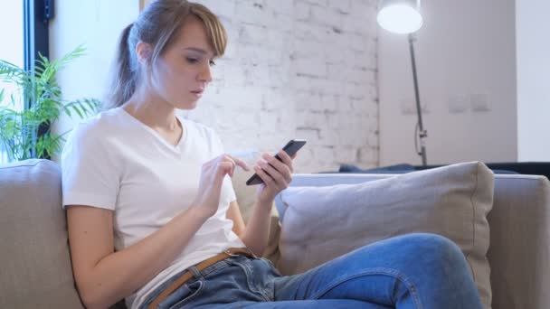 Woman Casually Using Smartphone Reacting to Loss — Stock Video