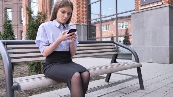 Mujer celebrando el éxito mientras está al aire libre usando Smartphone — Vídeos de Stock