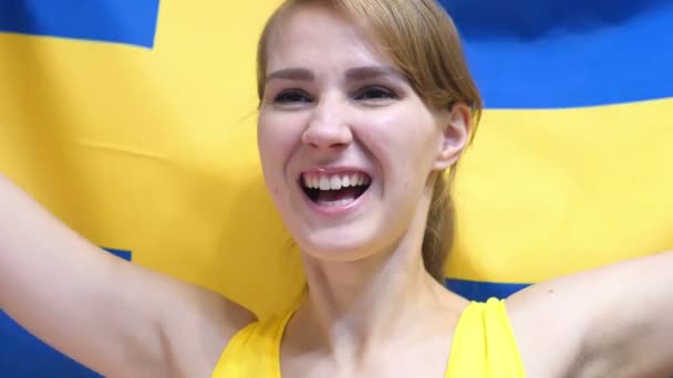 Swedish Young Woman Celebrating while holding the Flag of Sweden in Slow Motion — Stock Video