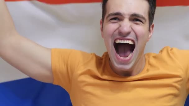 Niederländischer junger Mann feiert das Halten der Flagge der Niederlande in Zeitlupe — Stockvideo