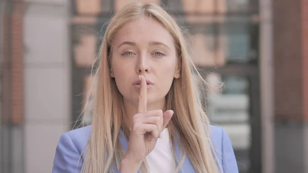Silence Please, Finger on Lips by Young Businesswoman