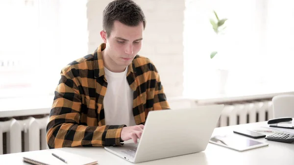 Internet Video Chat via Laptop by Casual Young Man