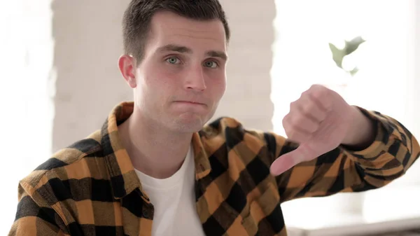 Thumbs Down by Casual Young Man Looking at Camera — Stock Photo, Image