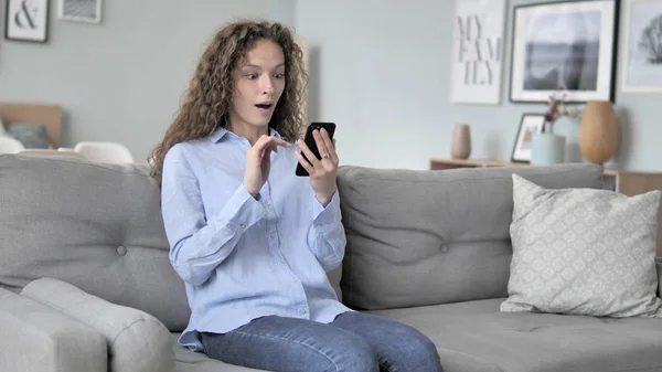 Relaxing Curly Hair Woman Cheering Success on Smartphone — Stock Photo, Image