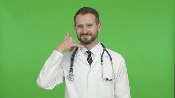 The Young Male Doctor Gesturing to Call Him for Help against Chroma Key — Stock Photo, Image