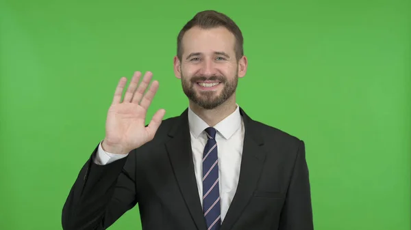 Az ambiciózus üzletember integetett Hand Sign ellen chroma key — Stock Fotó