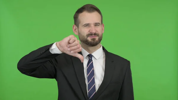 De jonge zakenman toont duimen naar beneden tegen Chroma Key — Stockfoto