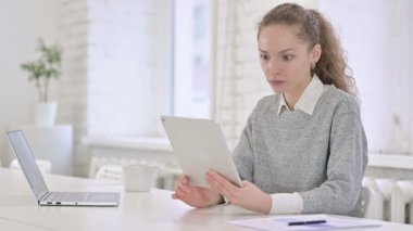 Unhappy Young Latin Woman reacting to Failure on Tablet 