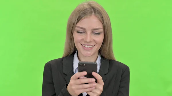 Young Businesswoman Using Smartphone against Chroma Key — Stock Photo, Image