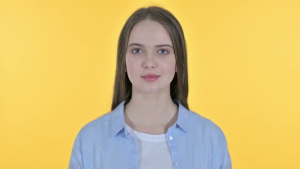 Casual Young Woman Looking at the Camera, Yellow Background — Stock Video