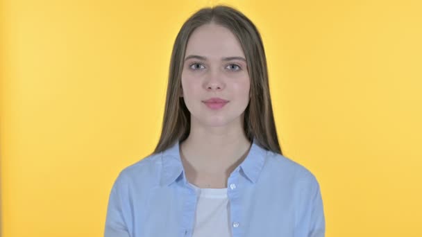 Casual Young Woman Pointing Finger at the Camera, Yellow Background — 비디오