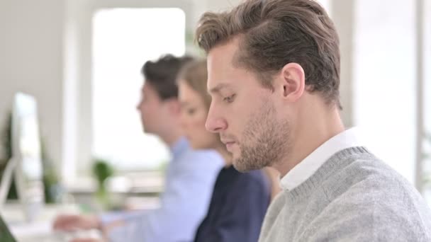 Retrato del hombre creativo y sonriendo a la cámara en la oficina moderna — Vídeo de stock