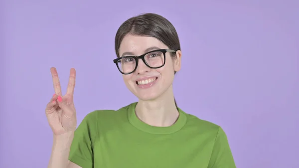 The Young Woman showing Victory Sign on Purple Background — 스톡 사진
