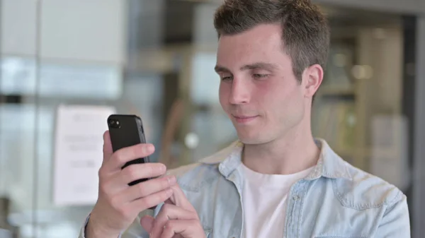 The Portrait of Focused Young Male Designer using Smartphone — Stock Photo, Image