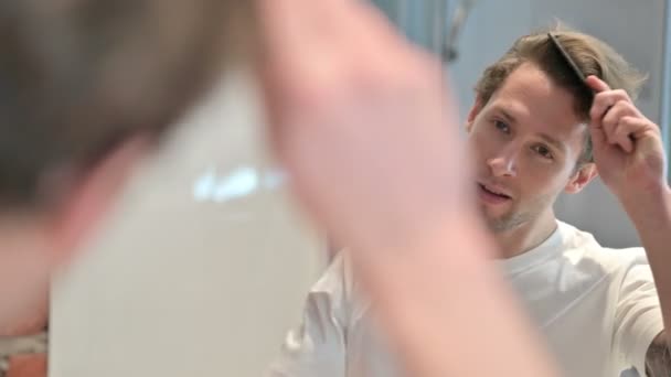 Rear View of Young Man doing combing Hair in Mirror — Stock Video