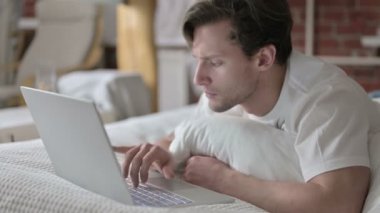 Genç Adam Başarı Kutlaması Dizüstü bilgisayarında Yatakta