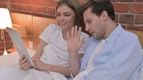 Young Couple doing Video Chat on Tablet in Bed — Stock Video