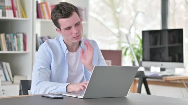 Młody człowiek z bólem szyi pracuje na laptopie — Wideo stockowe