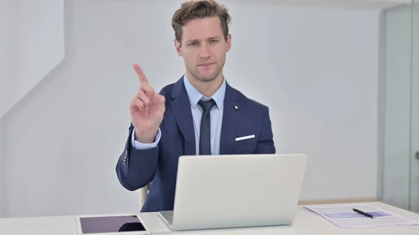 Young Businessman saying No by Finger in Office
