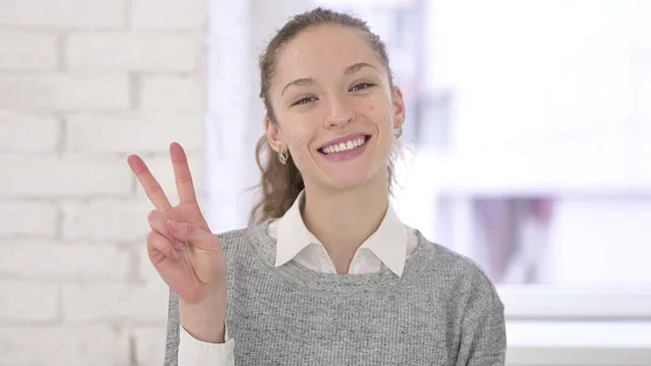 Portrait of Young Latin Woman showing Victory Sign — 스톡 사진